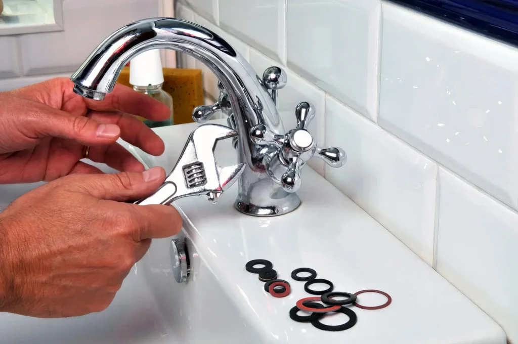 Plumber performing maintenance on a bathroom faucet in Plantation