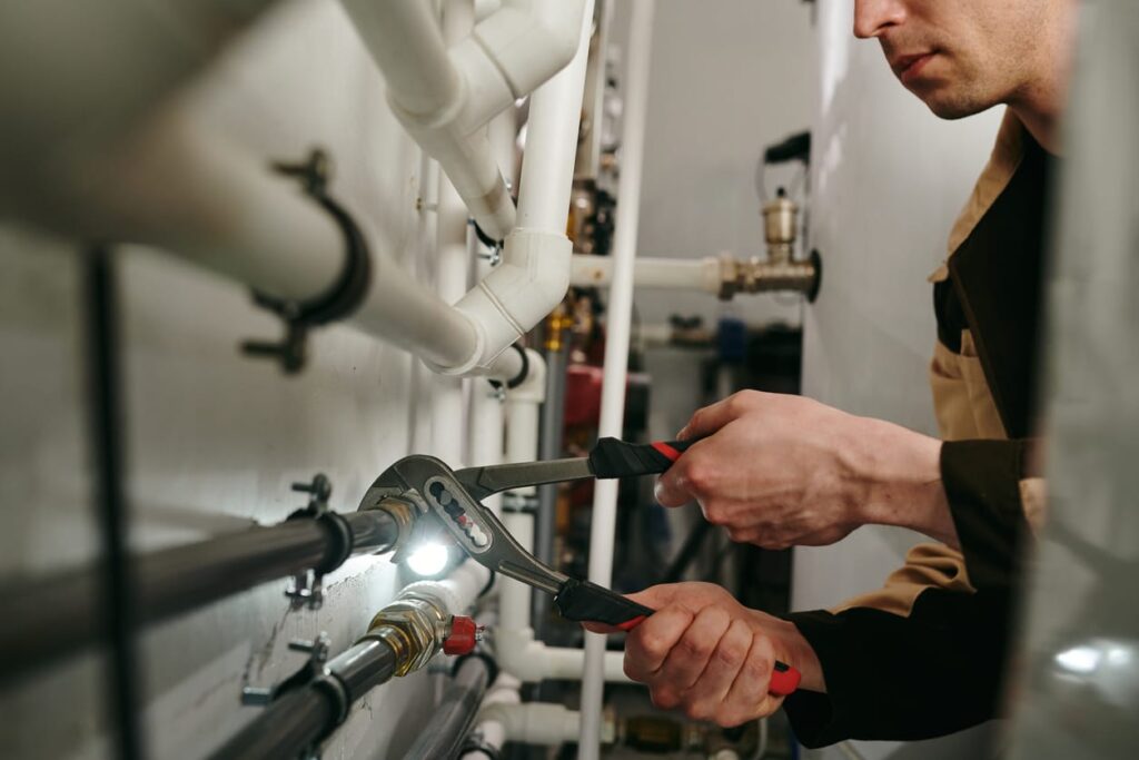 Plumbers maintaining commercial plumbing pipes in Plantation
