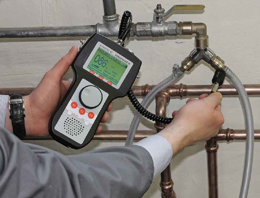 Plumber testing pipes with electronic leak detection equipment in Plantation