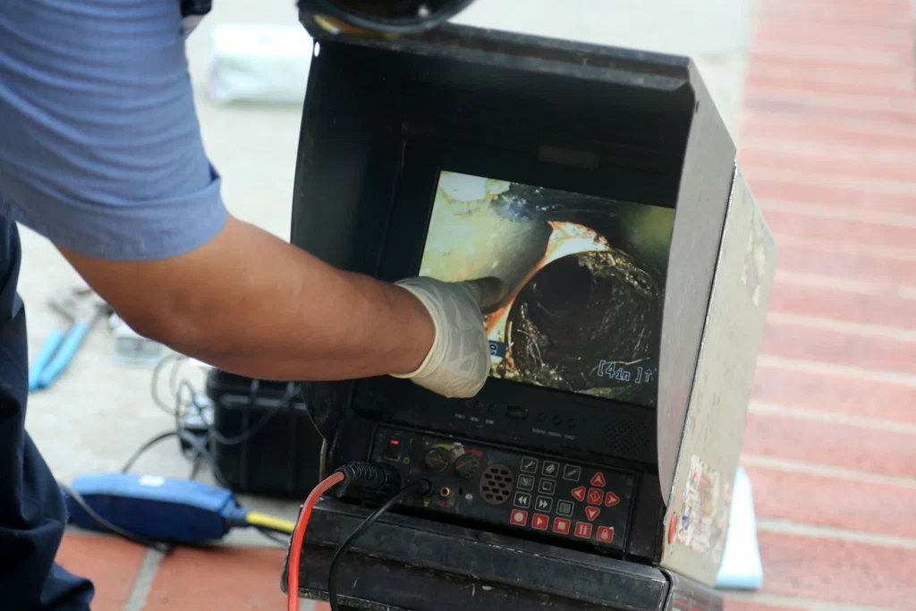 Technician viewing a drain inspection camera in Plantation