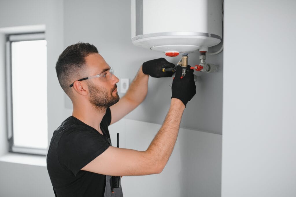 Technician performing water heater maintenance in Plantation