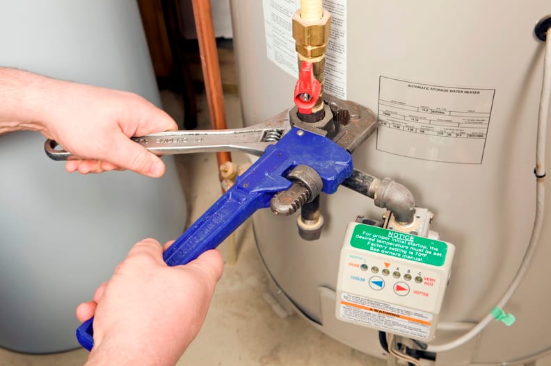 Plumber repairing a water heater valve in Plantation